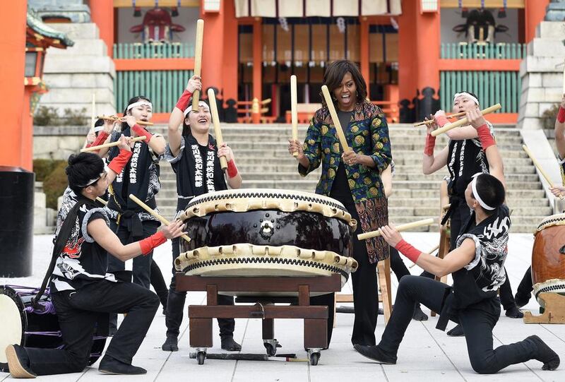US first lady Michelle Obama plays taiko drums with members of the Akutagawa High School Taiko Club during her visit at Fushimi Inari Taisha Shrine in Kyoto on March 20. EPA