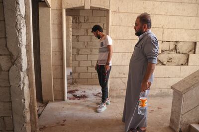 People inspect the damage after a landmine killed four children from the same displaced family in the Syrian town of Binnish. AFP