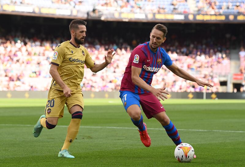 Luuk de Jong of Barcelona battles for possession with Jorge Miramon of Levante. Getty Images