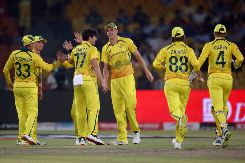 Australia's Sean Abbott, centre, celebrates with teammates after taking the wicket of Pakistan's Fakhar Zaman. AP