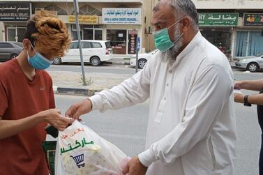 A Pakistani national who was laid off by his employer receives a bag of food. Courtesy - Consulate General of Pakistan