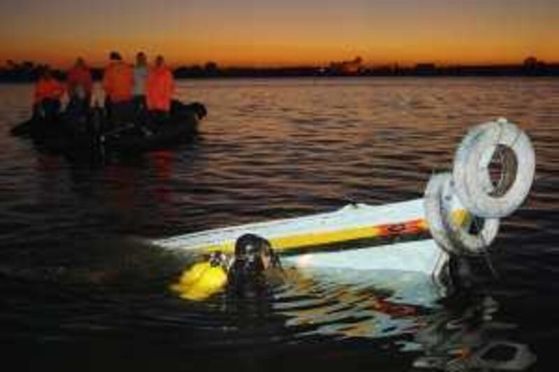 An Egyptian diver searches near a boat in the Nile river after it sank following a collision with another boat near the town of Rasheed in northern Egypt, early Saturday, Dec. 5, 2009.  An Egyptian security official says two motorboats used as a local ferry service collided and dozens of passengers are still reported to be missing.  Authorities are investigating the cause of the collision and trying to ascertain the numbers of people missing. (AP Photo/Amr Sharaf) *** Local Caption ***  XAN108_Mideast_Egypt_Boat_Accident.jpg