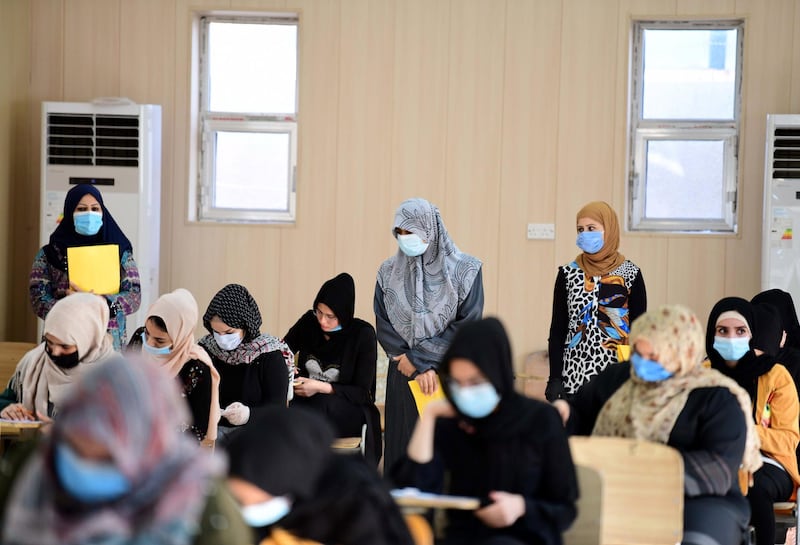 Iraqi high school students, wearing face masks, during their final exam after five months of schools closure due to the coronavirus pandemic, at a school in Baghdad, Iraq.  EPA