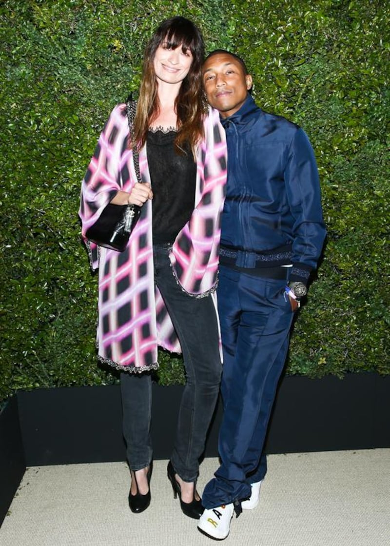 Caroline de Maigret, the event’s host and face of Chanel’s Gabrielle bag, wore a printed silk embroidered coat and blklhôhçyuçhack lace top from Chanel’s spring/summer 2017 ready-to-wear collection, along with the new Gabrielle bag and Chanel shoes. Co-host Pharrell Williams wore a navy silk jacket and pants from the autumn/winter 2017-18 ready-to-wear collection. Courtesy Chanel. Courtesy Chanel