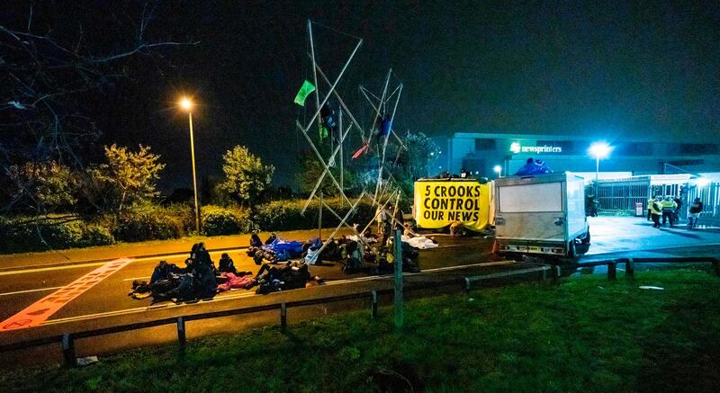 Extinction Rebellion activists blocking the entrance to the News Corporation newpaper printers at Broxbourne, Hertforedshire. Extinction Rebellion/AFP
