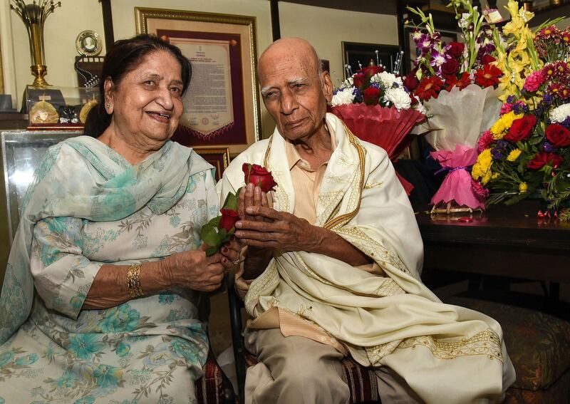 Khayyam poses for photographs along with his wife and singer Jagjit Kaur during his 92nd birthday celebration at his home in Mumbai on February 18, 2019.  AFP