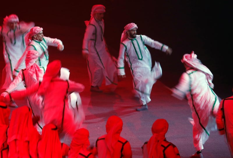Saudi dance troupe in traditional dress perform during a concert titled "mettle to the top" at the green hall theatre marking Saudi 89th National Day celebrations in Riyadh, Saudi Arabia, late Saturday, Sept. 21, 2019. (AP Photo/Amr Nabil)