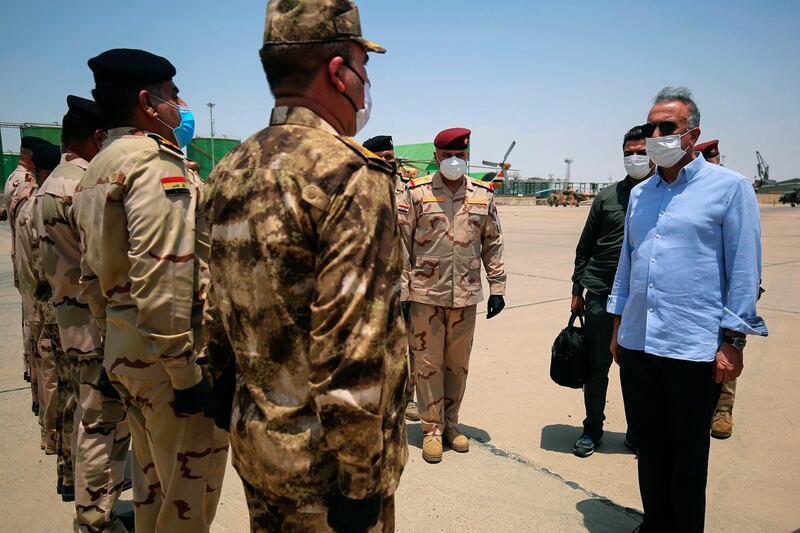 Iraq's Prime Minister Mustafa Al Kadhimi, right, arrives in Basra, Iraq. Pool Photo via AP