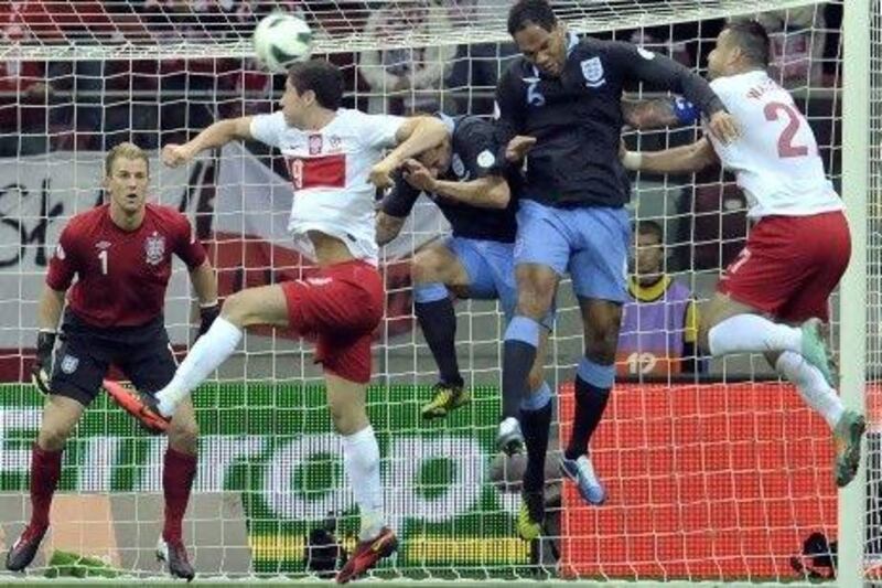 An error from Joe Hart, left, cost England two points in the World Cup qualifier in Poland.