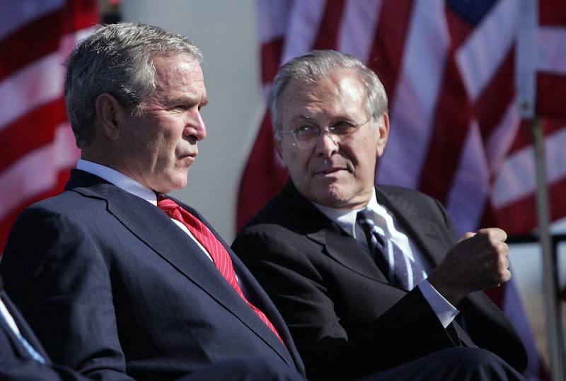 George W. Bush, left, talks to Donald Rumsfeld at the United States Air Force Memorial Dedication in Arlington, Virginia, in October 2006. AFP