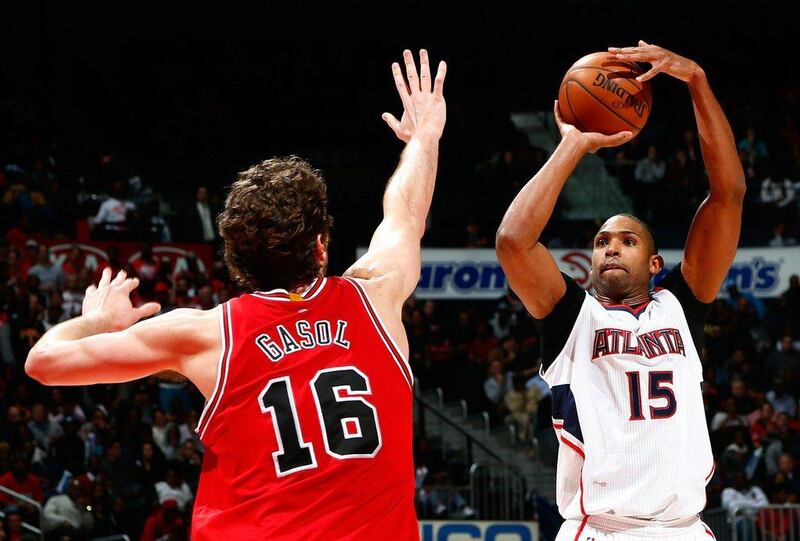 Al Horford of the Atlanta Hawks shoots over Pau Gasol of the Chicago Bulls during Atlanta's NBA win on Monday night. Kevin C Cox / Getty Images / AFP / December 15, 2014 