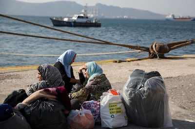 FILE PHOTO: Refugees and migrants wait to be transferred to camps on the mainland, at the port of Elefsina near Athens Greece, October 22, 2019. REUTERS/Costas Baltas/File Photo