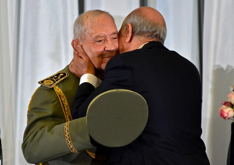 Algerian President Abdelmadjid Tebboune embraces and kisses Gen Ahmed Gaid Salah. AFP