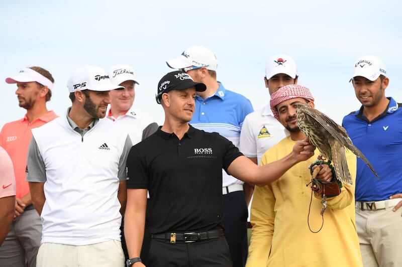 ABU DHABI, UNITED ARAB EMIRATES - JANUARY 14:  Henrik Stenson (C) of Sweden and Dustin Johnson (L) of the United States take part in a photocall for the Abu Dhabi HSBC Golf Championship at the Abu Dhabi Golf Club on January 14, 2019 in Abu Dhabi, United Arab Emirates.  (Photo by Ross Kinnaird/Getty Images)