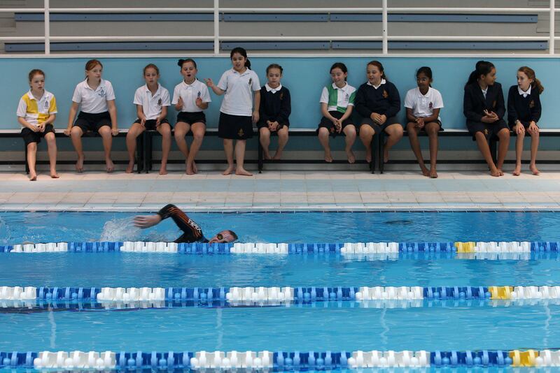 DUBAI , UNITED ARAB EMIRATES Ð Jan 23 : Students of grade five watching Edward Hawkins , teacher of Geography and History during the swimming at the Repton school in Dubai. ( Pawan Singh / The National ) For News. Story by Eugene Harnan