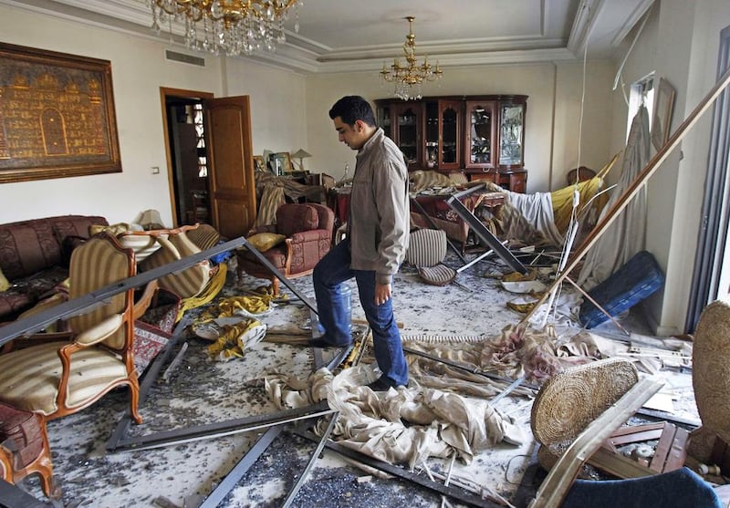 A Lebanese man inside a partially destroyed apartment near the Iranian embassy in Beirut. Anwar / AFP



