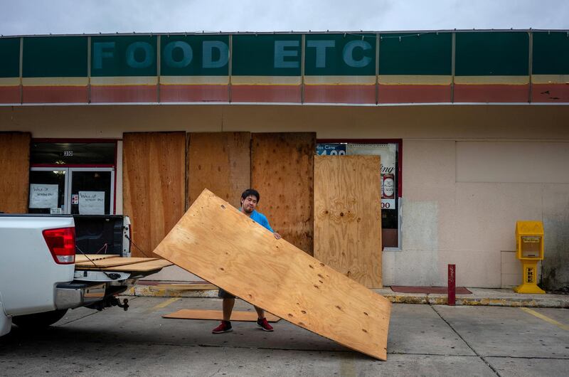 Trung Nguyen boards up his brother’s convenience store Food Etc in Abbeville, Louisiana, U.S., as Hurricane Laura approaches the gulf coast. Reuters