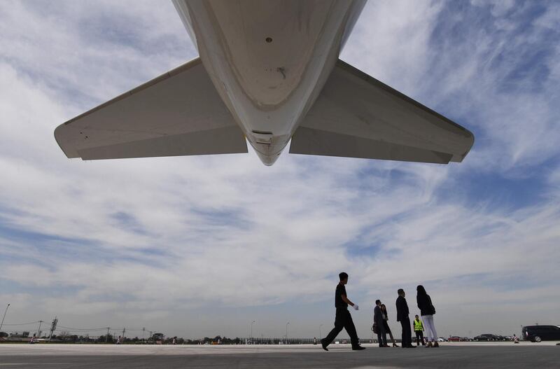 A security guard walks under the first Airbus A330 plane to be delivered after the inauguration ceremony of the Airbus Long Range Cabin Completion Centre in Tianjin, China on September 20, 2017.
Aerospace giant Airbus inaugurated a completion center for A330 widebody aircraft, which will provide cabin equipment, furnishing and exterior paint for the planes bought by Chinese airlines - a new selling point for the European group in the crucial and fast expanding Chinese market, where it experiences tough competition with its US rival Boeing. / AFP PHOTO / GREG BAKER