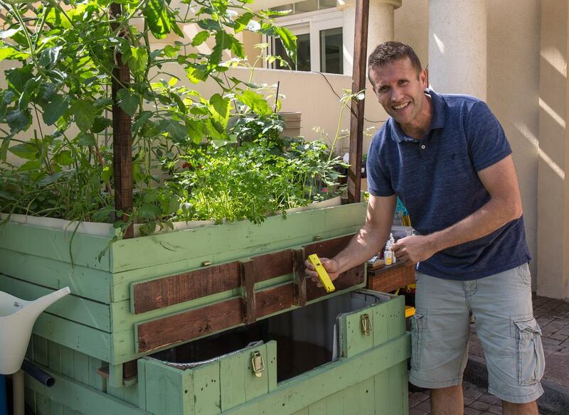 Jason Renoux with his home aquaponics system. Victor Besa for The National