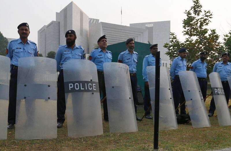 Pakistani police officers stand guard outside the supreme court in Islamabad. AP Photo