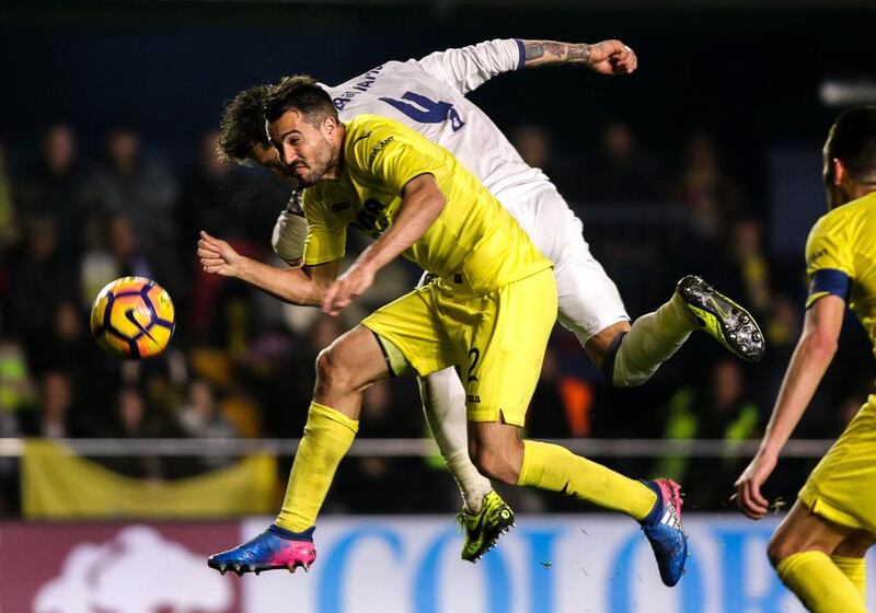 Real Madrid defender Sergio Ramos vies with Villareal defender Mario Gaspar, left. Biel Alino / AFP