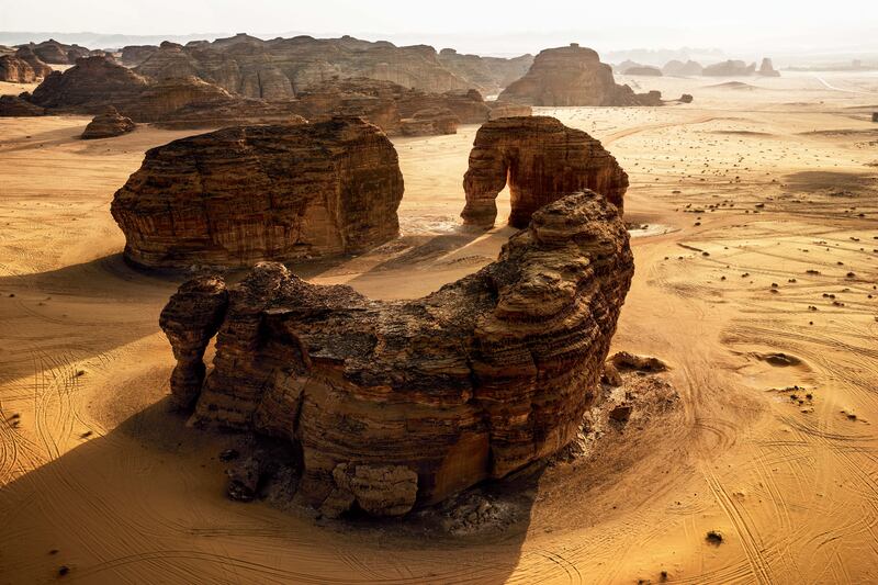 Red sandstone natural formations and Jabal Alfil (Elephant Rock).