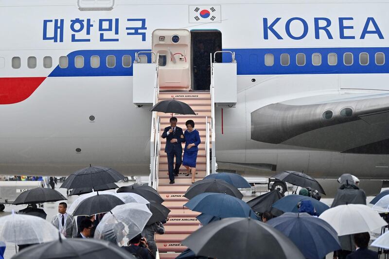 South Korea's President Moon Jae-in and his wife Kim Jung-sook arrive at Kansai airport in Izumisano city ahead of the G20 Summit in Osaka, Japan.  AFP