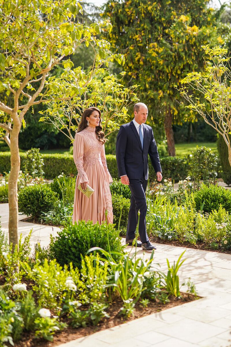 The Princess of Wales chose a blush pink long-sleeved dress  and kept her hair down in loose curls. PA