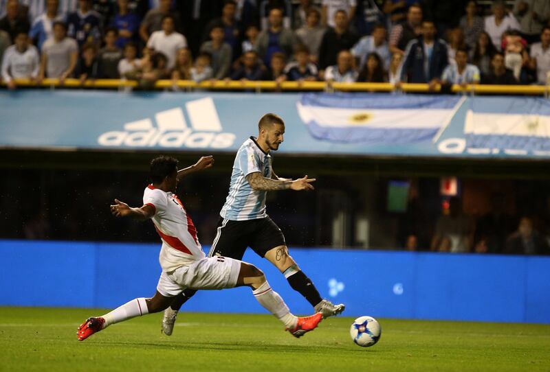 Dario Benedetto of Argentina and Miguel Araujo of Peru in action. Agustin Marcarian / Reuters