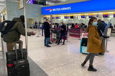 British travellers returning to their homes in Spain wait to speak to airline staff after they were refused entry onto planes, at London's Heathrow airport on Saturday Jan. 2, 2021. Dozens of British residents in Spain were refused travel because airlines refused to take in as proof of residency documents used until the United Kingdom's departure from the European Union at midnight on Dec. 31, 2020. (AP Photo/Max Duncan)