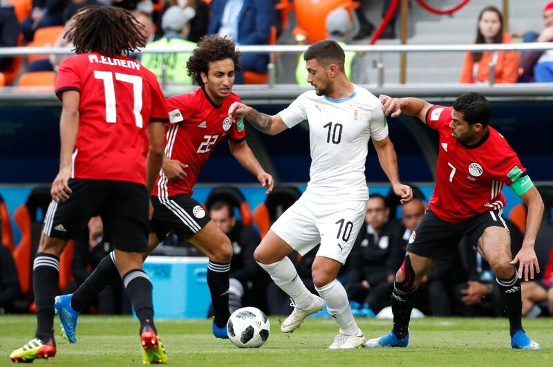 Egypt's Amr Warda, centre left, and Uruguay's Giorgian De Arrascaeta in action during their group A match at the 2018 FIFA World Cup at the Yekaterinburg Arena in Yekaterinburg, Russia, on June 15, 2018. Atef Safadi / EPA