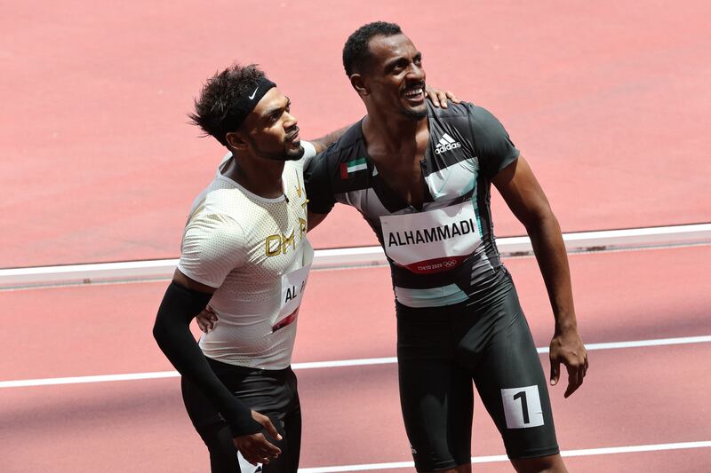 Oman's Barakat Al Harthi (L) with the UAE's Mohamed Hassan Al Noobi Al Hammadi after their 100m heat at the Olympic Stadium.