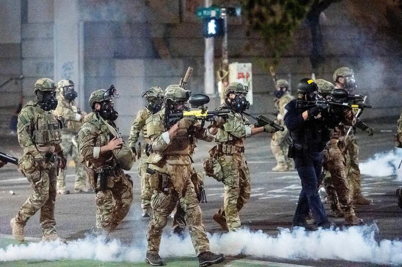 Federal officers use chemical irritants and crowd control munitions to disperse Black Lives Matter protesters in Portland. AP