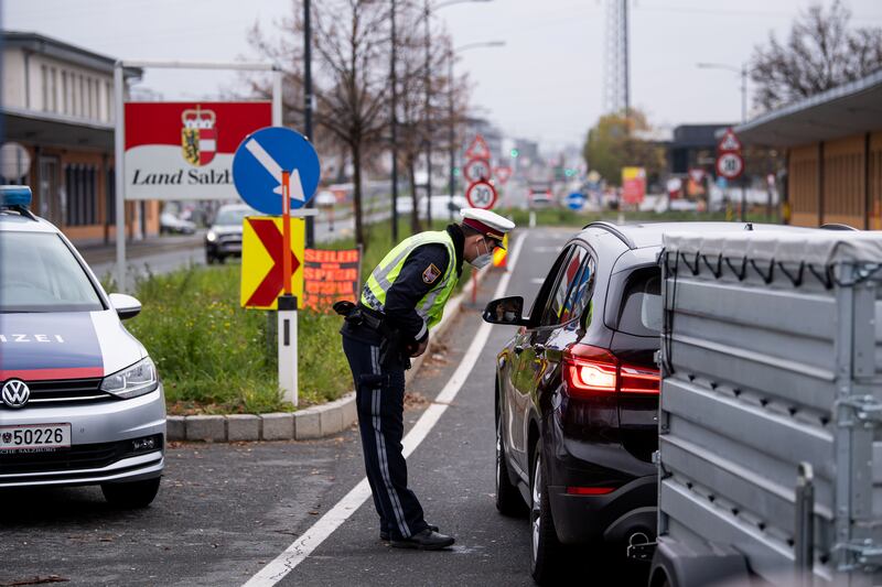 Police officers at a checkpoint at the German-Austrian border in Salzburg talk to motorists as a nationwide coronavirus lockdown takes effect in Austria. Germany is also looking at its precautions. Reuters