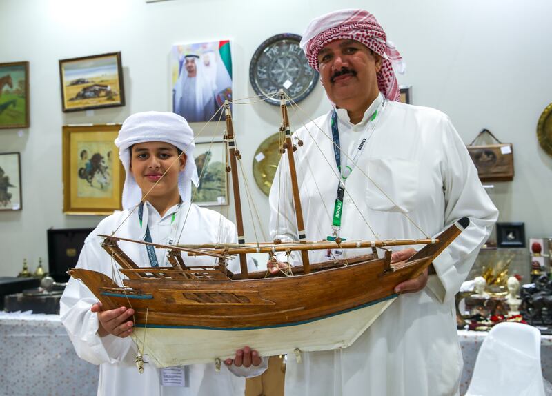 (L-R) Ahmed Mansour and father, Jameel of UK Antiques Events stall at Abu Dhabi International Hunting and Equestrian Exhibition. Victor Besa / The National