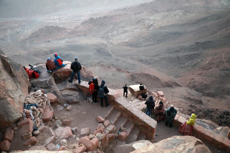 Tourists watch the sunrise outside a church on the top of Mount Moses in Saint Catherine city, South Sinai, Egypt. EPA