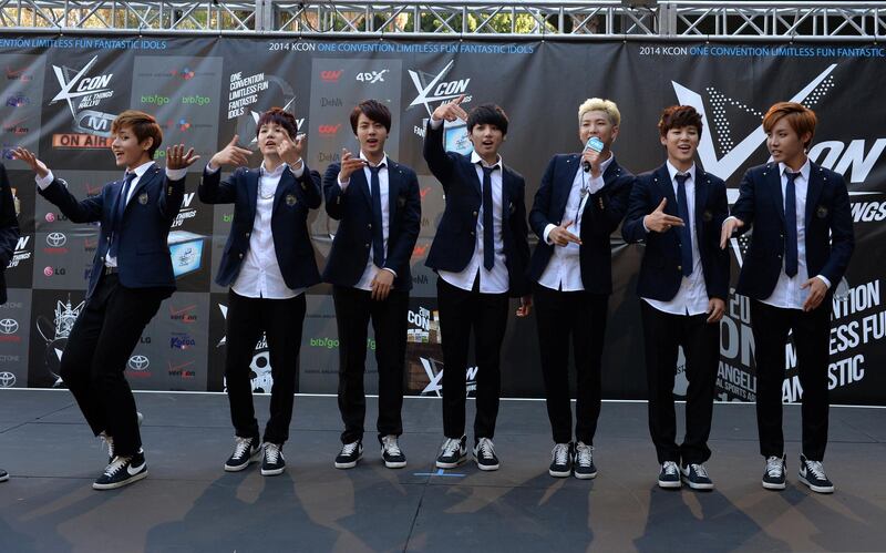 Members of Korean K-pop group BTS arrive on the red carpet during the K-CON 2014 (Korean Culture Convention) at the Los Angeles Memorial Sports Arena on August 10, 2014.  Having taken Asia by storm over the past decade with bubblegum looks and dance moves infused with military precision, South Korea's K-pop phenomenon continues to defy cultural barriers and find fans around the world. More Korean bands have multilingual members who can sing verses, carry choruses, and conduct interviews in English, Chinese, and Japanese so language is no longer a barrier.            AFP PHOTO/Mark RALSTON (Photo by MARK RALSTON / AFP)
