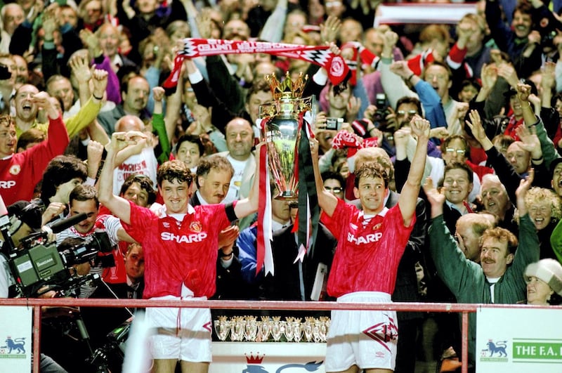 8 May 1993:  Steve Bruce and Bryan Robson of Manchester United celebrate with the premiership trophy after clinching the title during the FA Carling Premiership match against Coventry City played at Old Trafford in Manchester, England. \ Mandatory Credit:Allsport UK /Allsport