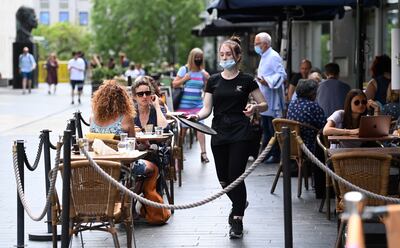Customers at a restaurant in London, Britain. Some sectors, such as hospitality, are struggling with labour shortages. EPA