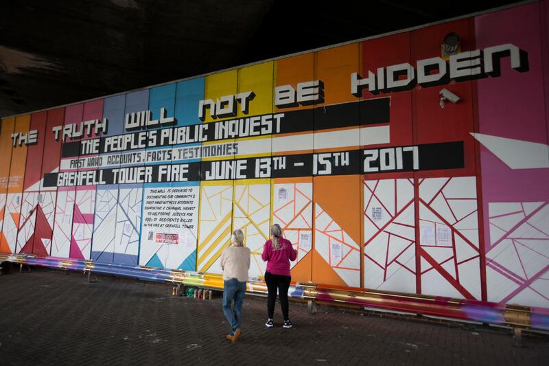 The Truth Wall covered in colourful graffiti artwork. It invites residents to ask and answer questions about Grenfell, its inhabitants and the tragedy that befell them.