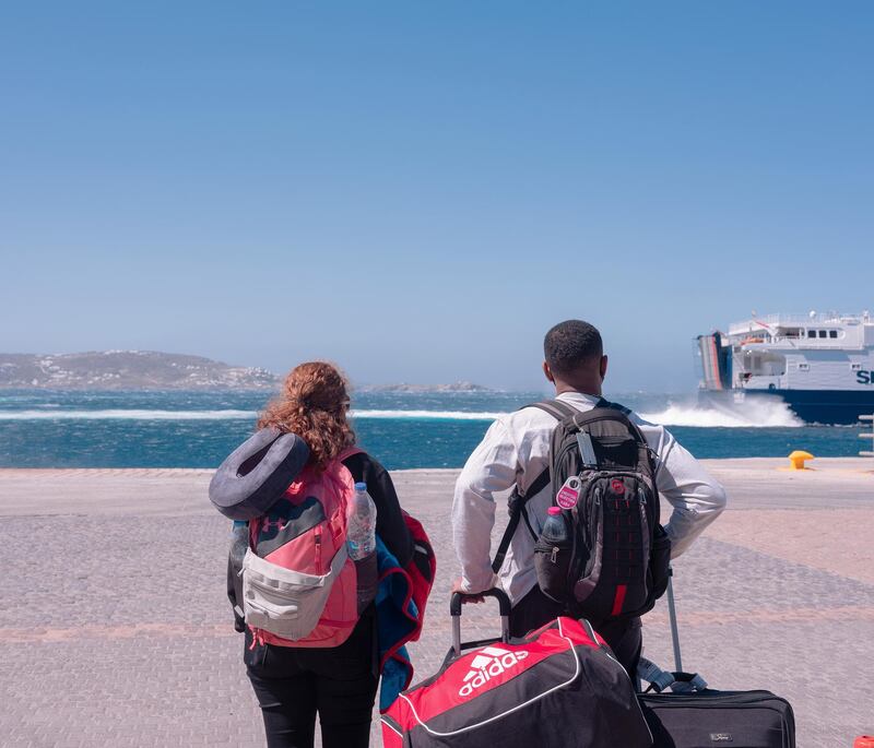 Tourists wait to board the Seajets fast ferry to Naxos, arriving from Piraeus. Photographer: Loulou D'Aki/Bloomberg