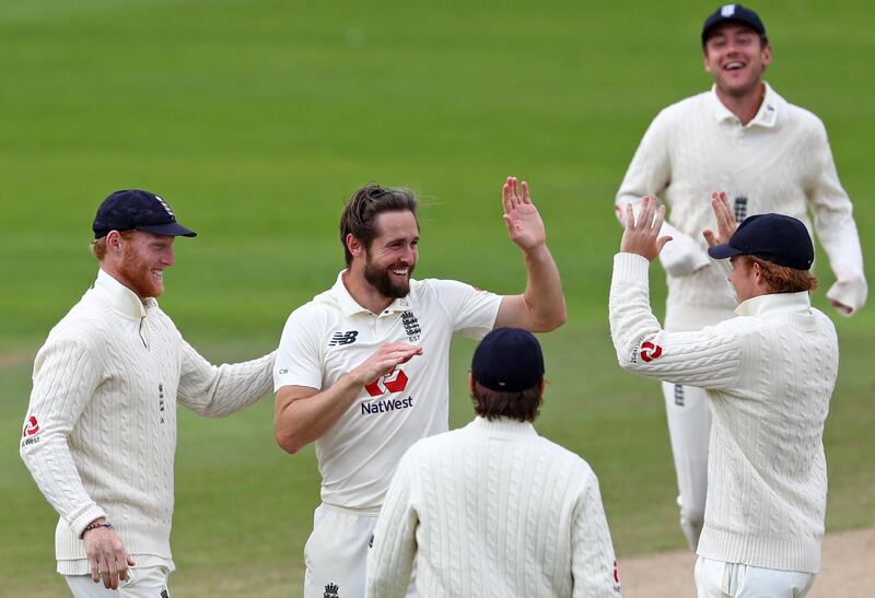 England's Chris Woakes, second left, celebrates with team mates after taking the wicket of West Indies' Rahkeem Cornwall. AFP