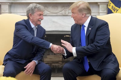 US President Donald Trump shakes hands with Danny Burch, an American who was held hostage in Yemen for 18 months, in the Oval Office of the White House in Washington, DC, March 6, 2019. (Photo by SAUL LOEB / AFP)