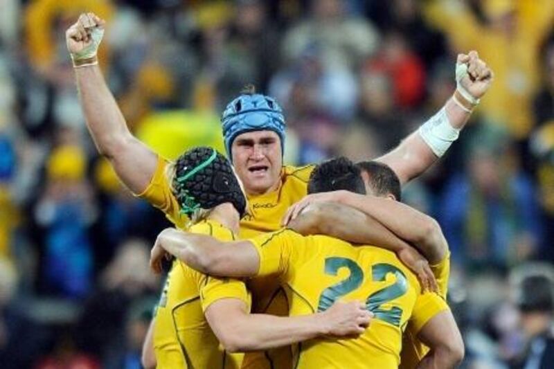 James Horwill, centre, celebrates with Berrick Barnes, left, and Anthony Faingaa after defeating South Africa.