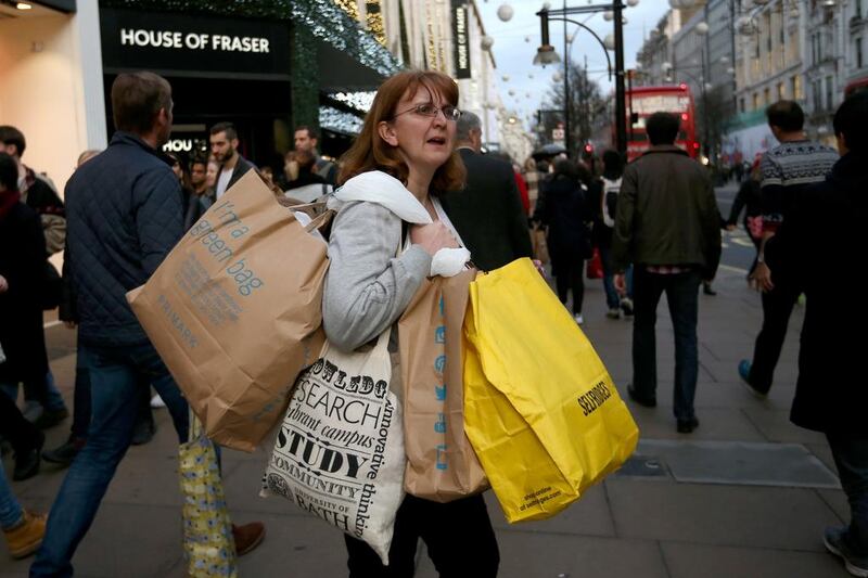 A woman carries several shopping bags as she shops on Oxford Street in London, England. Why are women being charged more for the same product? (Photo by Carl Court/Getty Images)