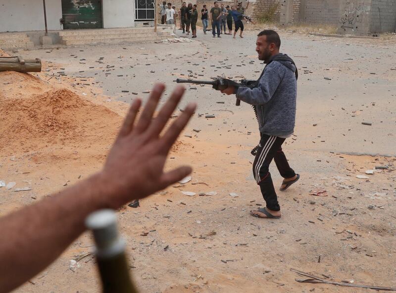 A GNA fighter pulls the trigger on his rifle. Reuters