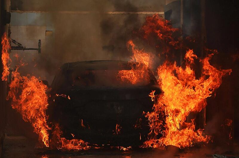 A car is set ablaze during fighting between Islamist militias and forces loyal to a retired general Khalifa Haftar, in Benghazi, Libya. Maher Alawani / EPA