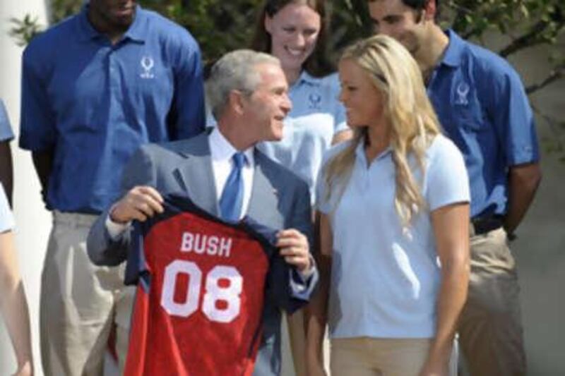 The US President George W Bush receives a softball jersey from the Team USA softball pitcher Jennie Finch