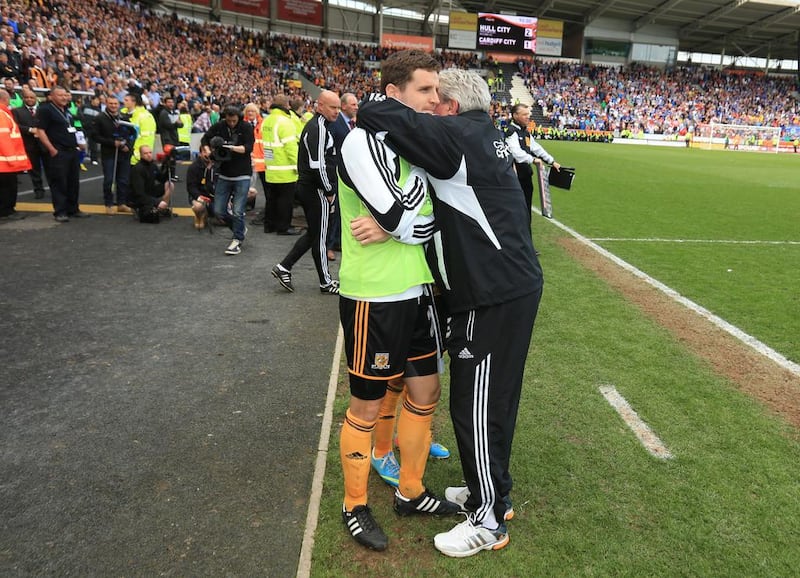 Hull City manager Steve Bruce embraces his son, Alex, before a last-minute penalty kick. Mike Egerton / PA Sport