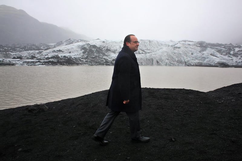 French president Francois Hollande looks at the effects of climate change on the Solheimajokull glacier in Iceland.  (Thibault Camus / EPA)